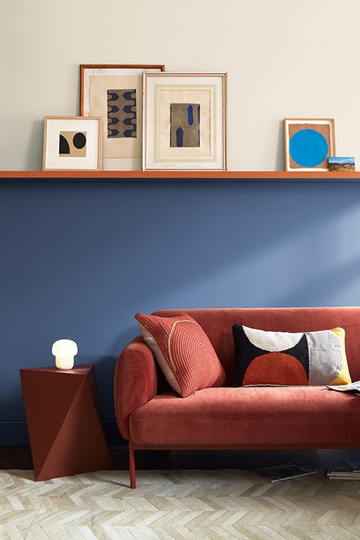 A living room with upper wall painted in White Dove OC-17, lower wall painted with Blue Nova 825, separated with a shelf painted in Topaz 070