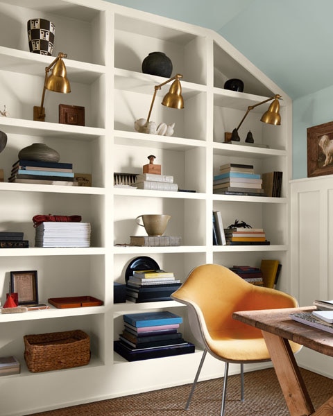 A study with built-in shelving unit painted in Swiss Coffee OC-45 and upper walls and ceiling painted in Raindance 1572.